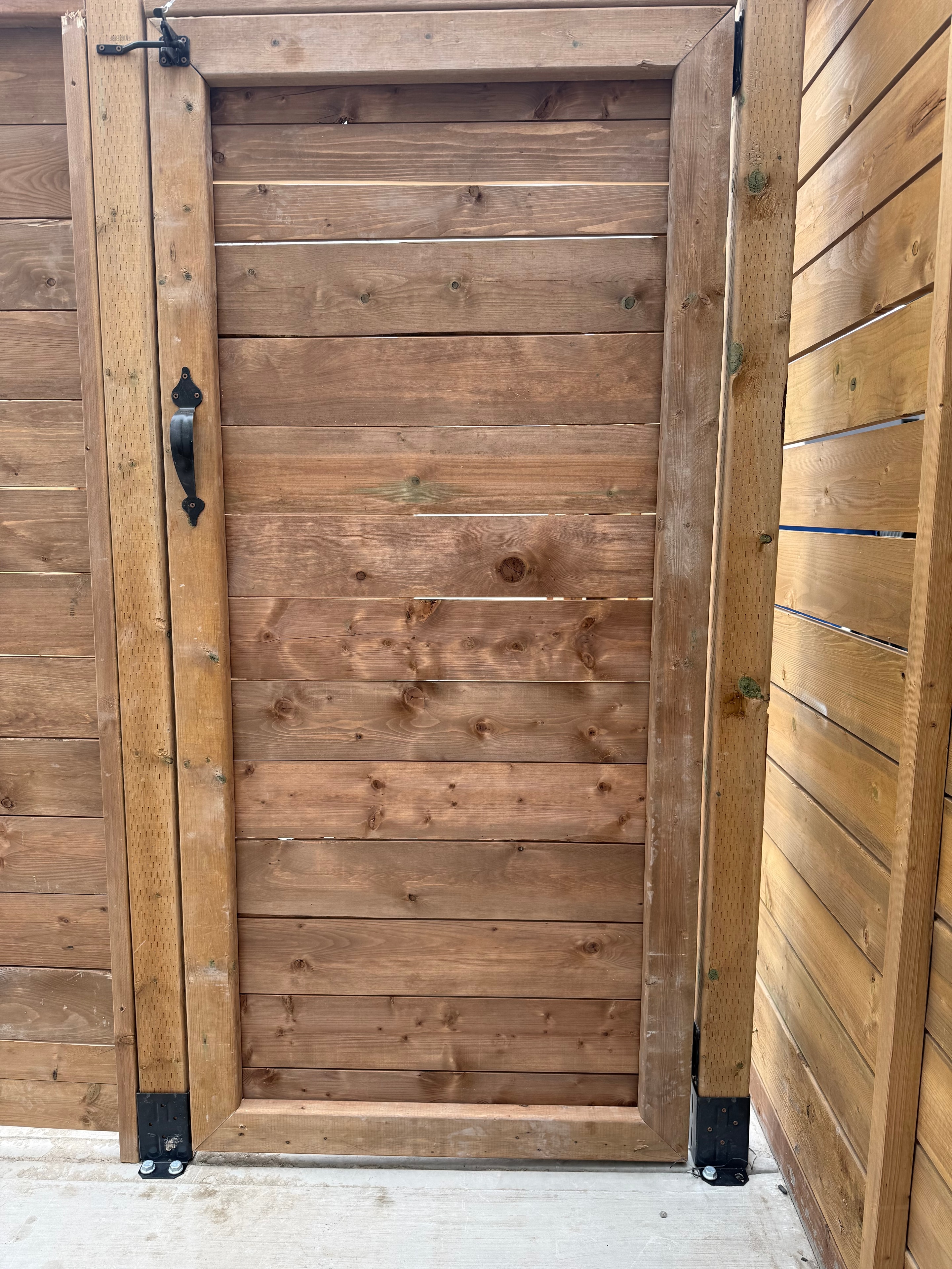 Wooden fence door installation by Tri-Star
