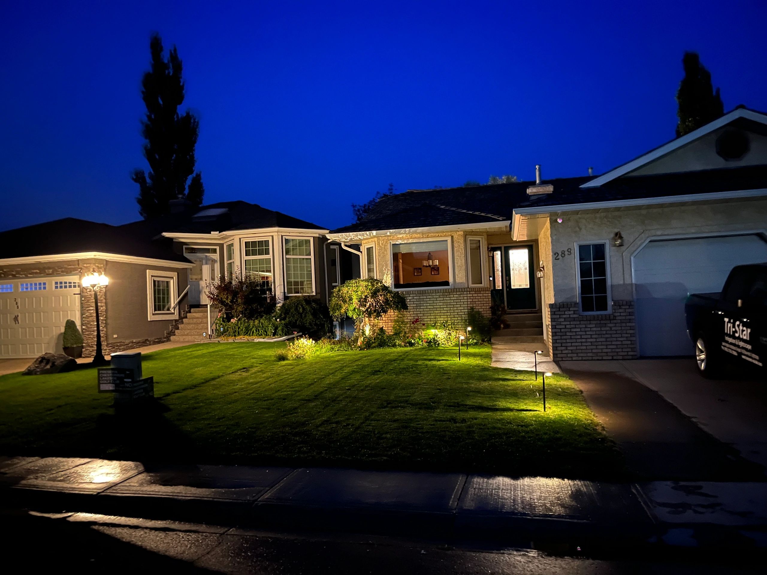 Twilight home with landscape lighting